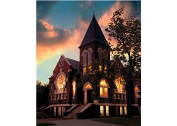 historic building at sunset with glowing windows