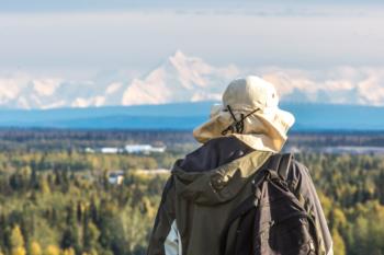 person looking at distant mountains