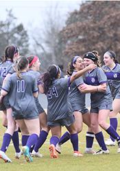 women's soccer team celebrating