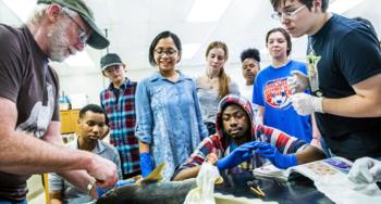 biology lab activity with students and a teacher