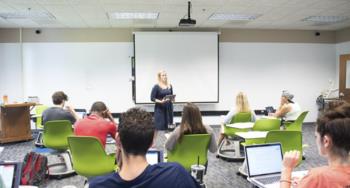 students in a classroom focusing on a presentation