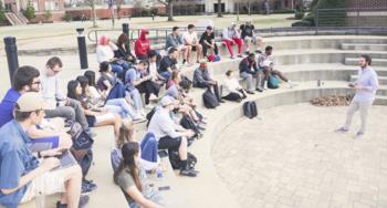 outdoor class with students seated in a semi-circle