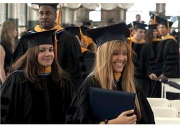 graduates smiling with diplomas