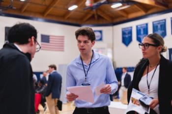 Menlo College students engaging in a networking event on campus.