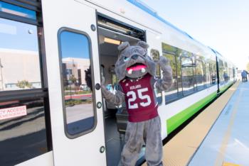 University of Redlands bulldog mascot waving from the Arrow train