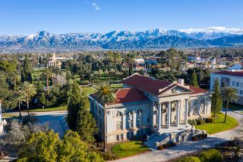 Administration Building at University of Redlands with snowy mountains in background