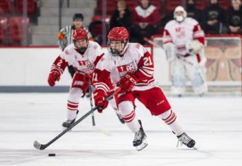 SHU club ice hockey players in red and white uniforms on the rink