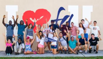 students posing with 'I love FAU' sign
