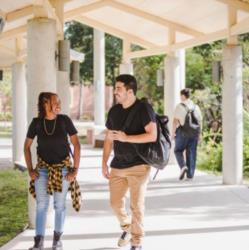 students walking under covered walkway