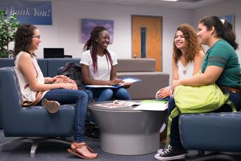 students chatting on lounge sofas
