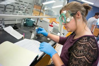 student taking notes in a laboratory