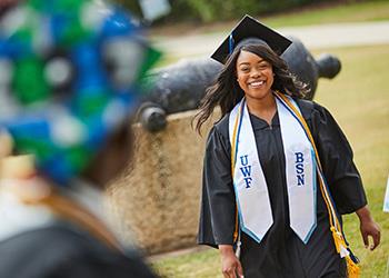graduating student smiling outdoors