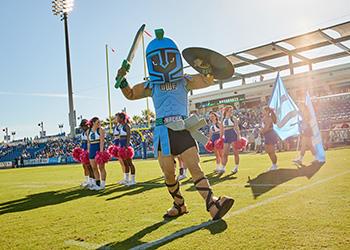 mascot with cheerleaders at a sports event