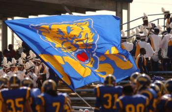 blue and gold flag with a wildcat over a football team