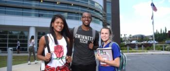 students smiling in front of gwinnett technical college building