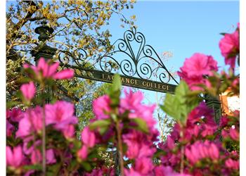 entrance sign of 'LaGrange College' behind pink flowers