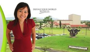 woman in front of campus banner 'define your world with us'