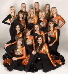 group of cheerleaders in orange and black uniforms