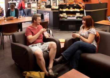 two students chatting in a lounge area