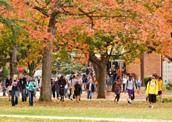 students walking on a college campus in fall