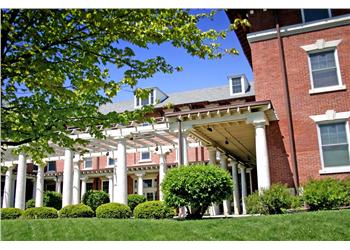 historic building with columns and green lawn