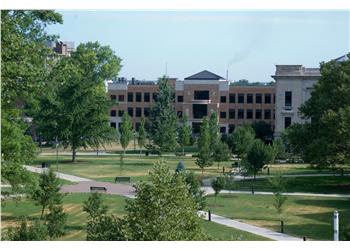 campus buildings viewed across green lawns