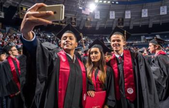 graduates taking a selfie at ceremony