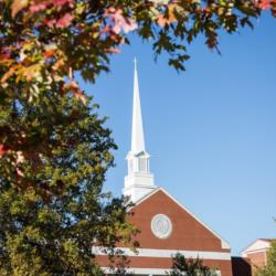 church steeple behind autumn leaves