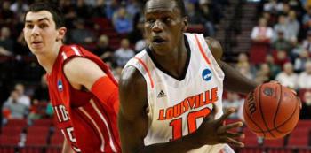 basketball player in white 'louisville 10' jersey dribbling