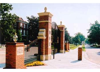 campus entrance with brick pillars and gate labeled MSU