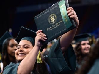 Delgado Community College smiling graduate