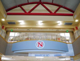 interior view of a hall with red beams and a 'N' logo