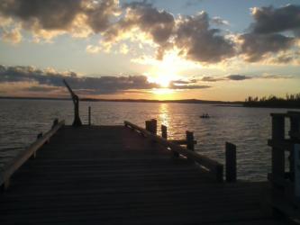 sunset view from a wooden pier over a lake