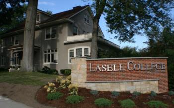 brick sign with 'Lasell College' in front of a building
