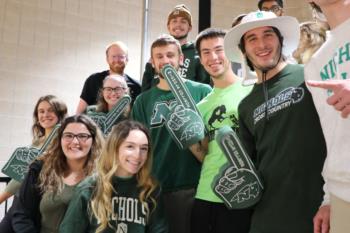 group of students with foam fingers and school spirit wear
