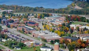 aerial view of college campus with lake in the background