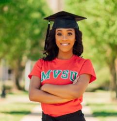 graduate in cap and gown with 'MVSU' shirt