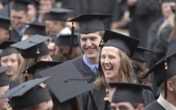 graduates laughing and wearing caps