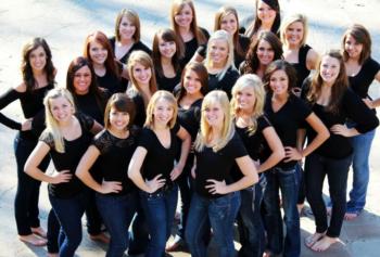 group of people smiling in black tops