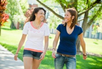 two students walking and chatting on campus
