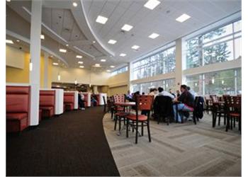 indoor lounge area with students and tables