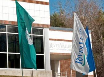 flags in front of 'River Valley' campus building
