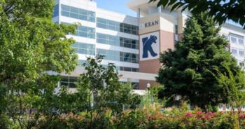 modern building with 'kean' logo and lush greenery