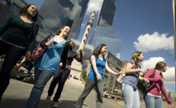 students walking, skyscrapers in the backdrop