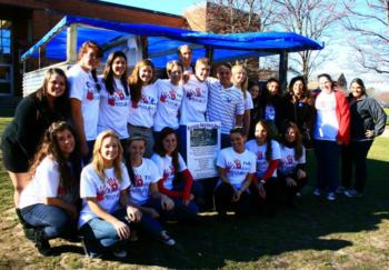 group of students with a banner at an outdoor event