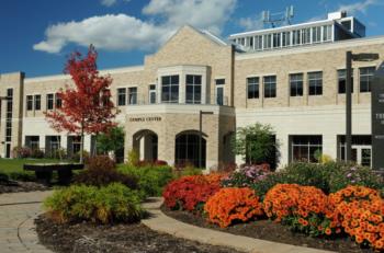 campus building with flower garden
