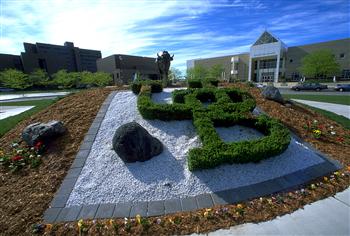landscaped garden with institution's initials