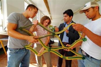 students examining large architectural model