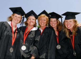 graduates smiling in cap and gown