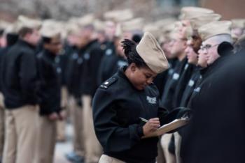 cadets in uniform writing notes